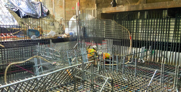 Electricians working on a large, commercial electrical construction installation project